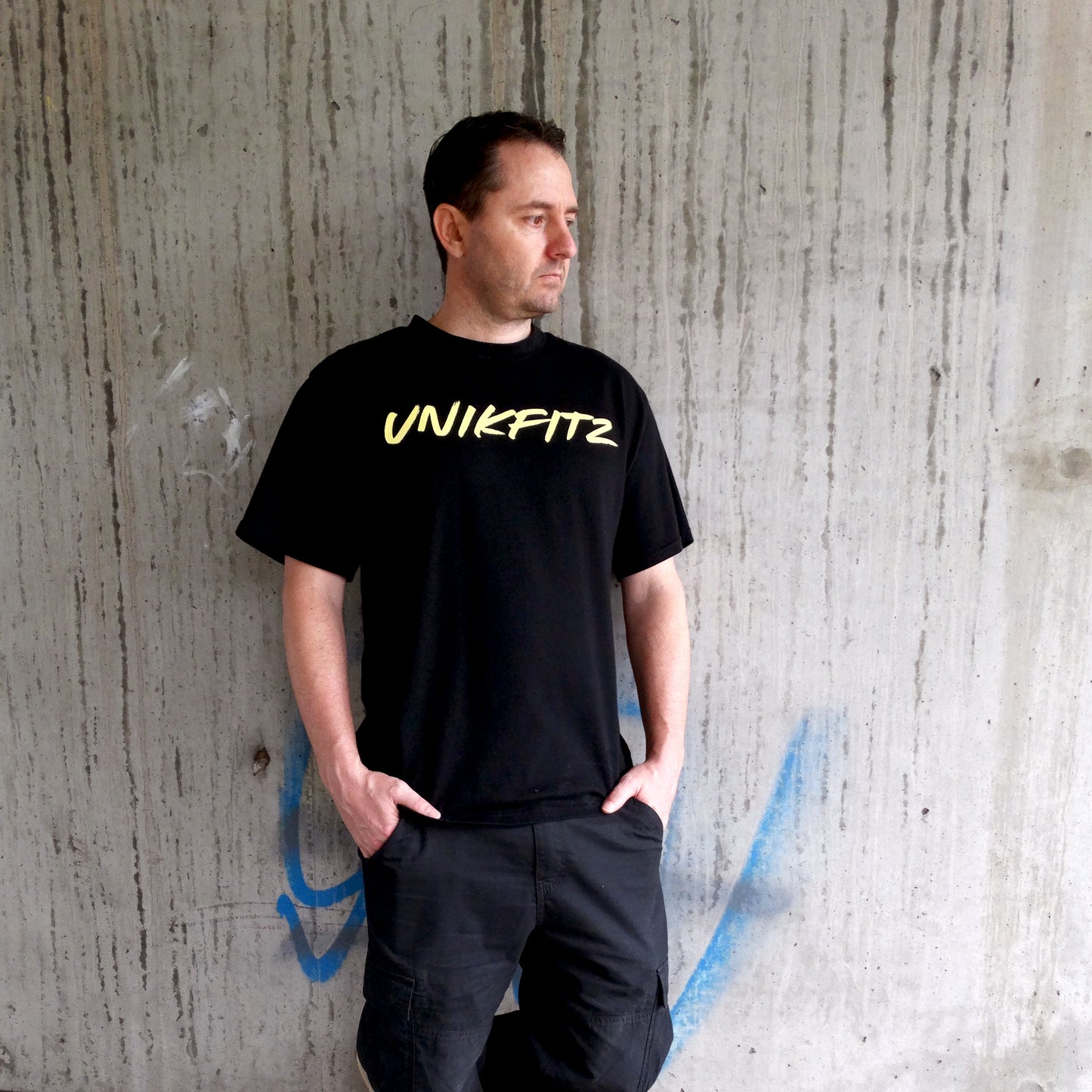 Full-body shot of a model wearing the Rise & Soar Men's T-Shirt, showcasing its oversized fit and bold phoenix back graphic. This essential men's t-shirt combines street wear vibes with gym-ready durability, making it a must-have in Australian men's clothing.