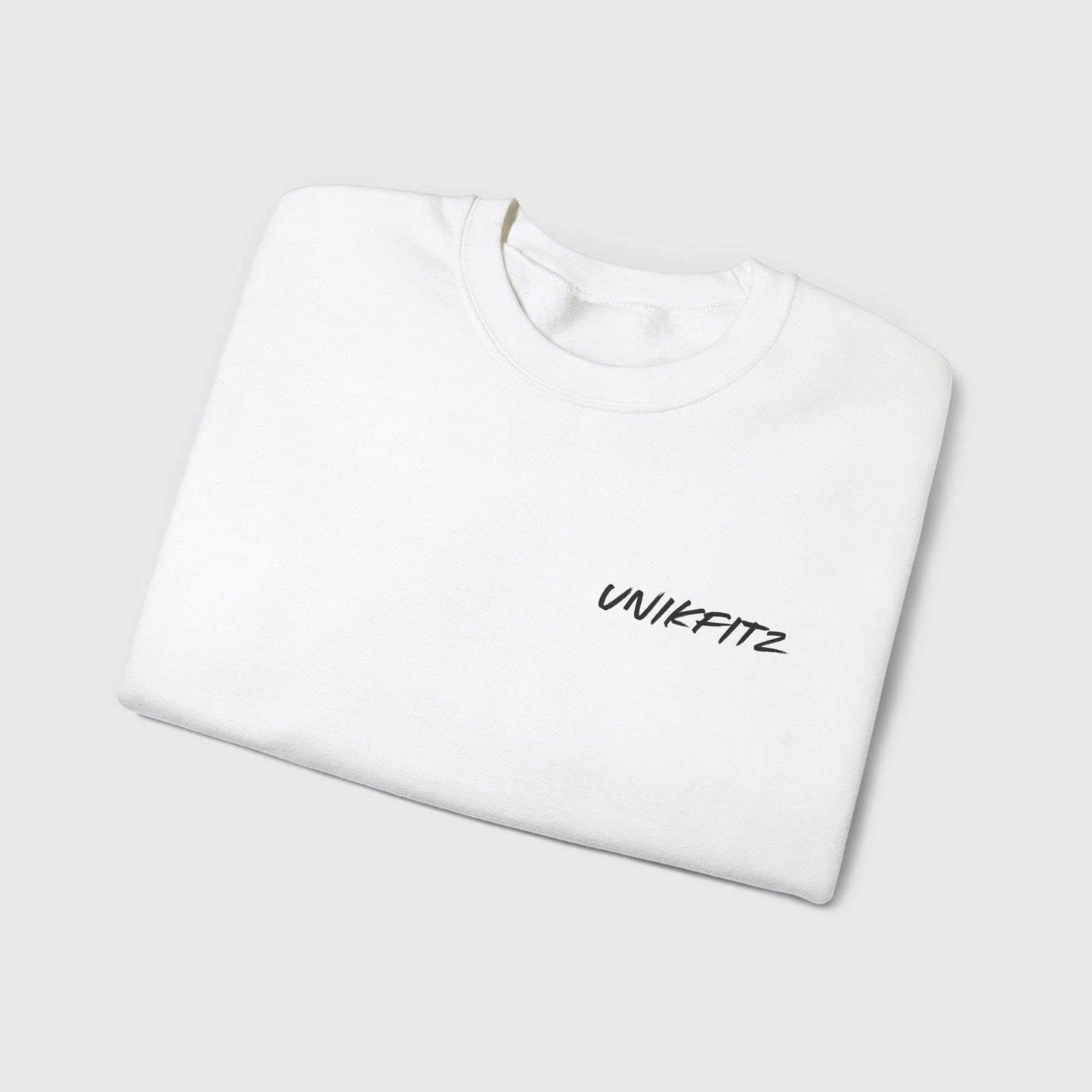 Folded white men's sweatshirt featuring a sleek 'Unikfitz' logo on the chest, perfect for street wear, gym sessions, and casual outings. An essential sweatshirt for men combining comfort and style.