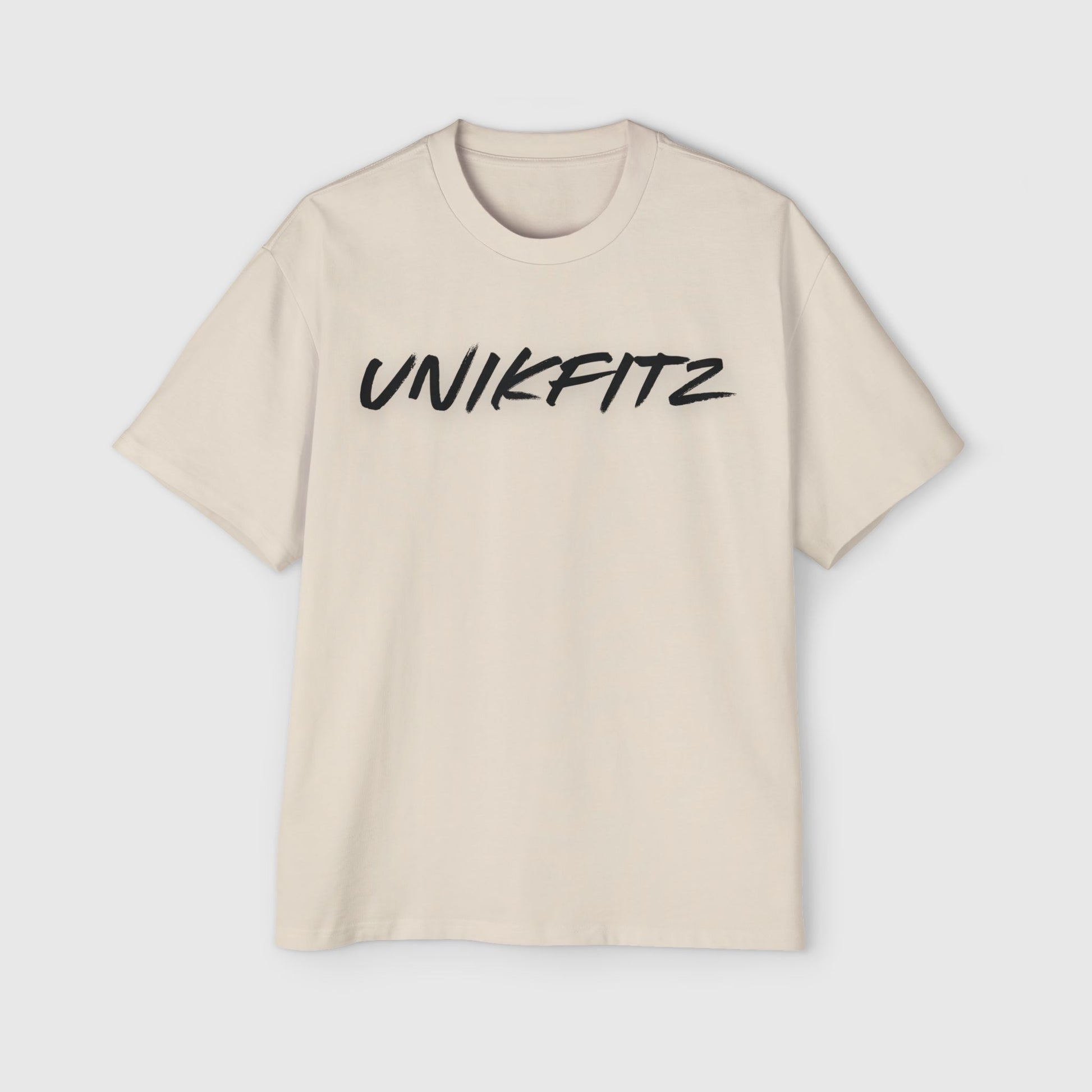 Front view of a cream oversized T-shirt with 'UNIKFITZ' logo, a must-have essential sweatshirt for men’s street wear wardrobe