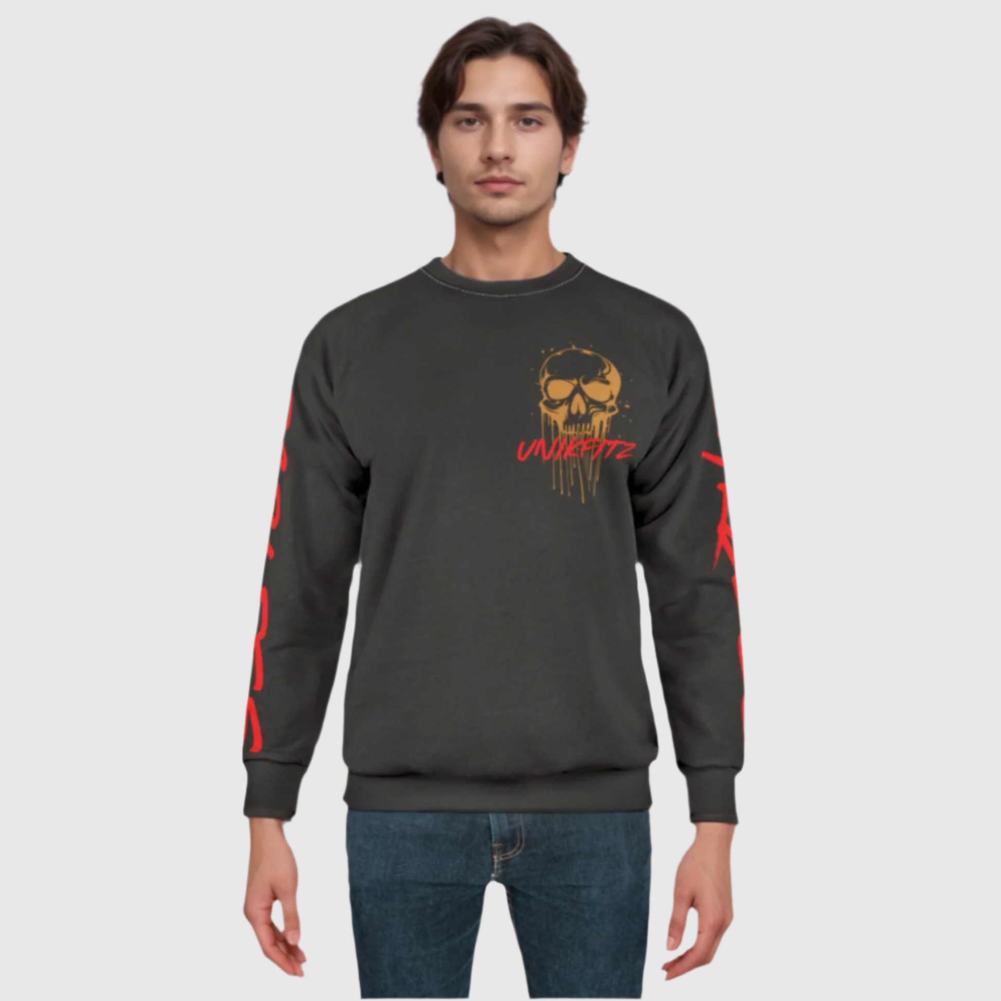 Model wearing a charcoal gray essential men's sweatshirt with a bold dripping gold skull graphic and 'UNIKFITZ' in red on the front. The red 'FEARLESS' lettering on the sleeves complements the rugged street wear aesthetic. A versatile piece for casual men's wear.