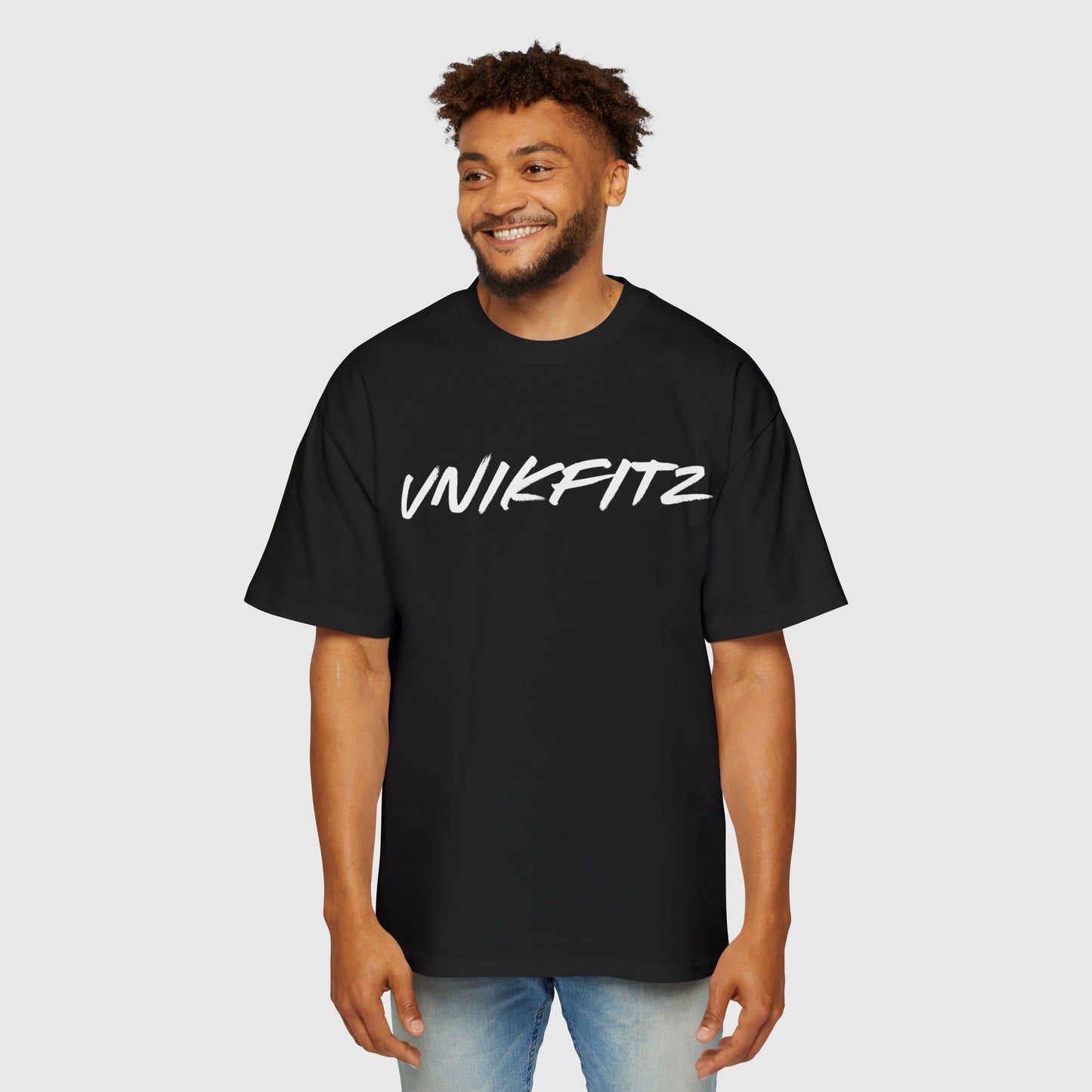 Full view of a man wearing a black oversized t-shirt with "UNIKFITZ" branding, perfect for street wear, men's clothing gym, and versatile men's wear styles