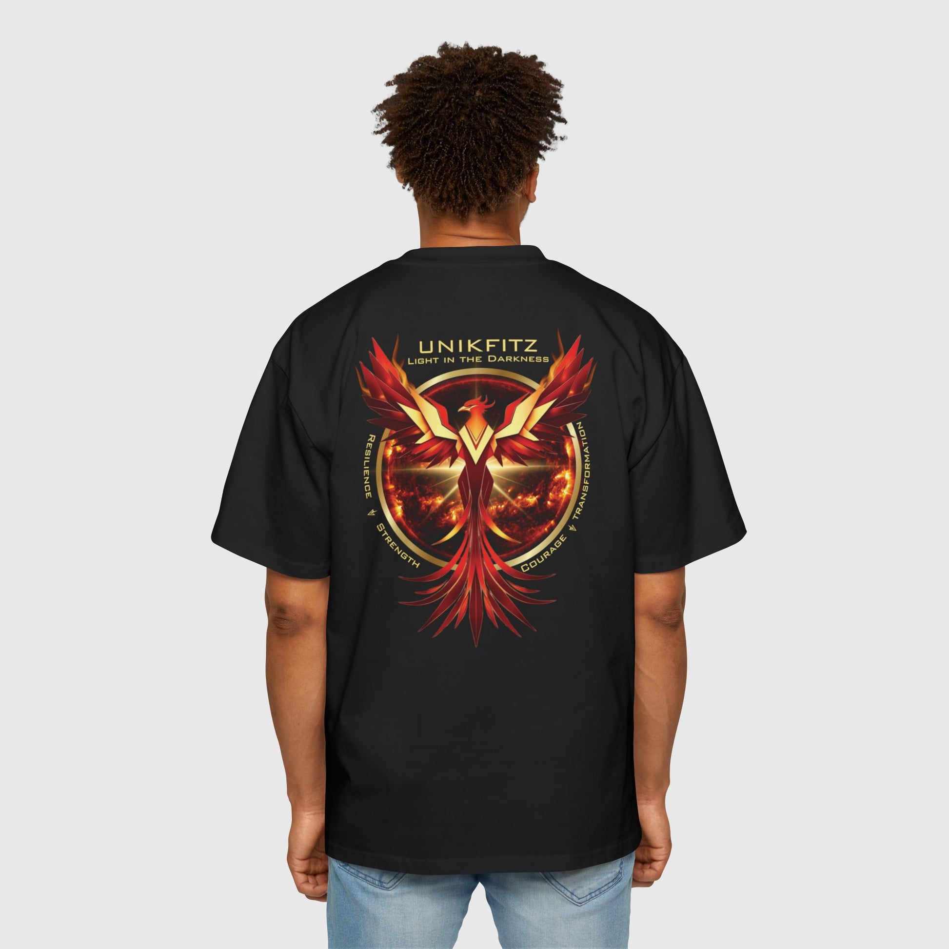 A black UNIKFITZ men's t-shirt with a vibrant phoenix graphic in red and gold on the back. The design symbolizes resilience, courage, and transformation, ideal for gym wear or casual street style, crafted for men's clothing enthusiasts