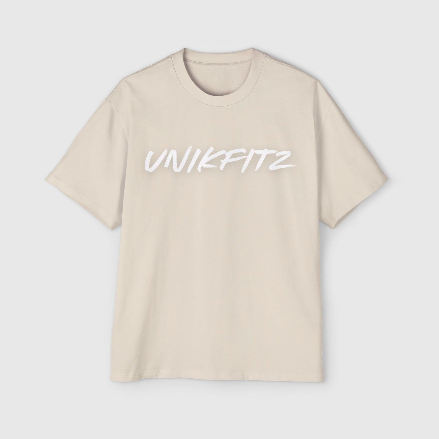 Beige oversized T-shirt with bold "Unikfitz" text on the front, a versatile essential sweatshirt for men’s wear and street wear style