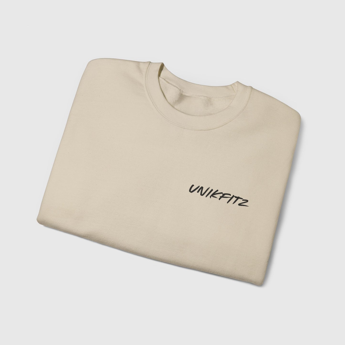 Folded beige essential sweatshirt featuring the UNIKFITZ logo on the chest, designed for street wear enthusiasts and ideal for gym or casual outfits in men's clothing.