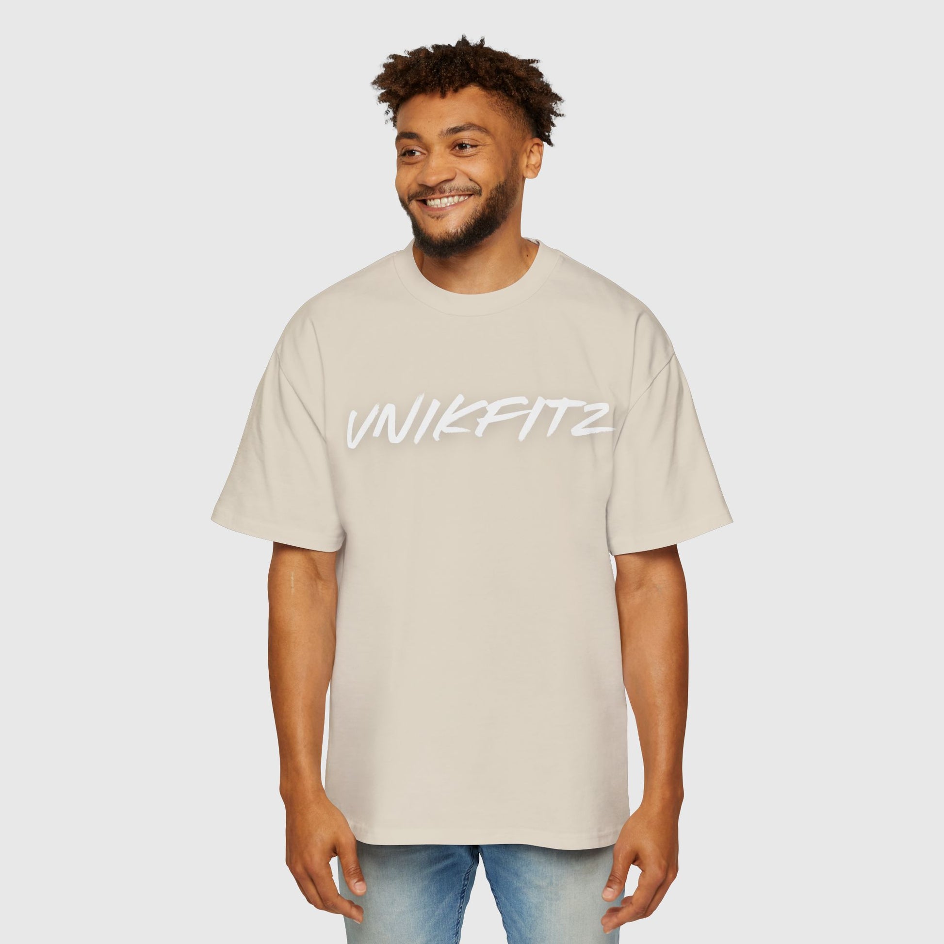 Front view of a men's oversized t-shirt in light beige with 'UNIKFITZ' logo printed across the chest. Stylish men's clothing gym, street wear, essential t-shirt for men