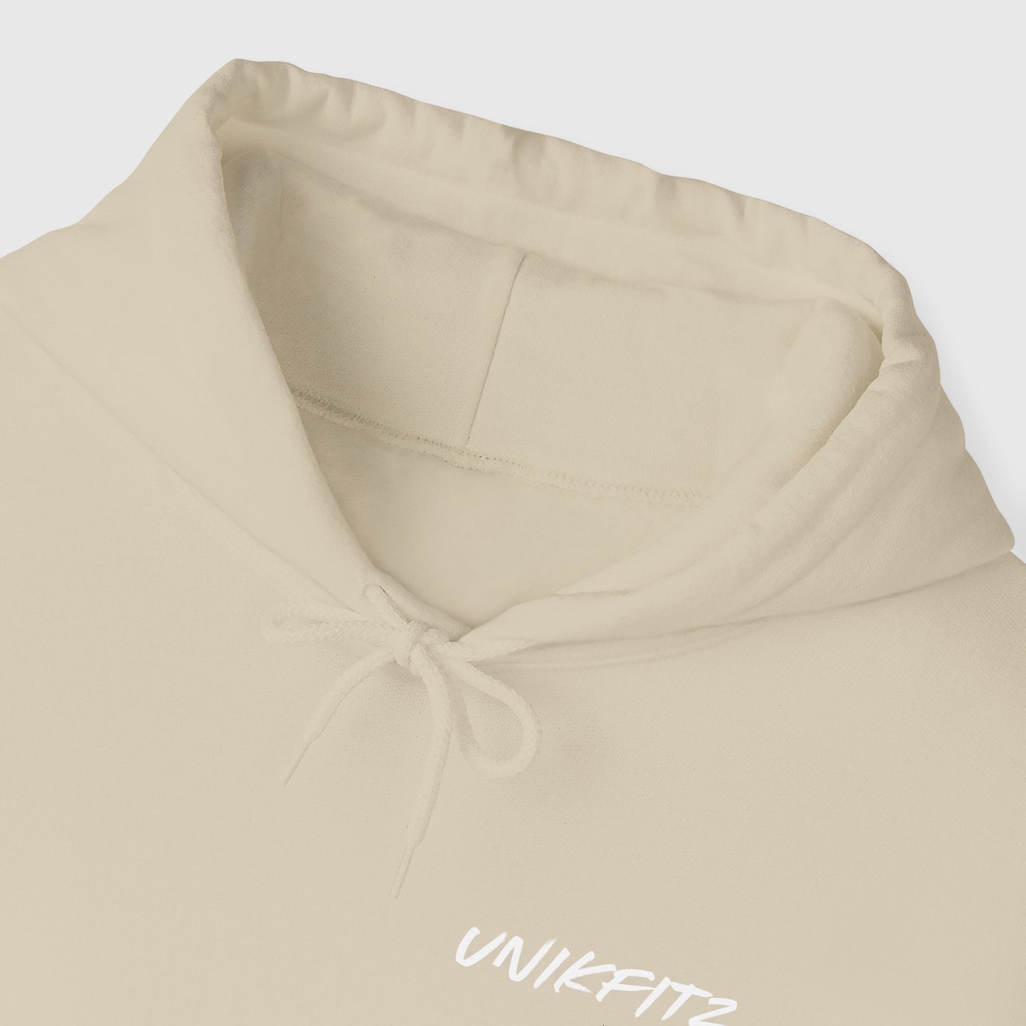 Close-up of the UNIKFITZ hoodie neckline in a beige color, showcasing the soft, durable fabric and minimalist design. A staple piece in men's clothing gym and street wear