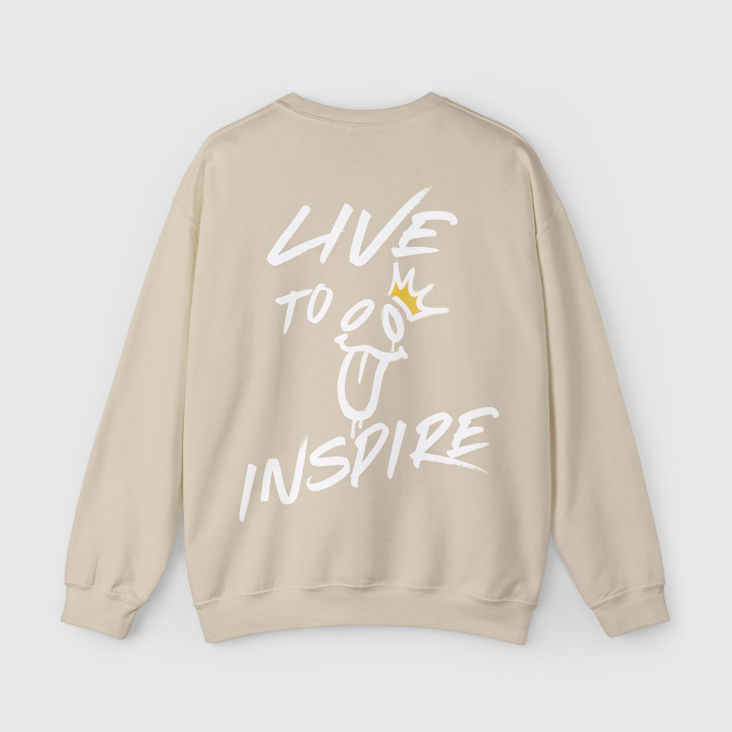 Back view of a beige sweatshirt with bold "Live to Inspire" graffiti-style text and a whimsical crown-topped design. A street wear essential sweatshirt for making a statement.