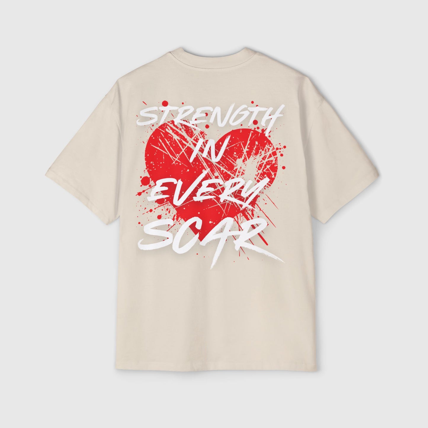 Back view of a light beige men's t-shirt featuring a bold red heart design with white splatter and text 'Strength in Every Scar.' Perfect street wear, t-shirt essential, and men's wear.