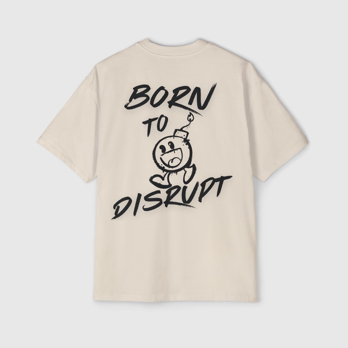 Men's sand oversized t-shirt featuring 'Born to Disrupt' slogan and a cartoon bomb illustration in edgy black text, essential street wear.