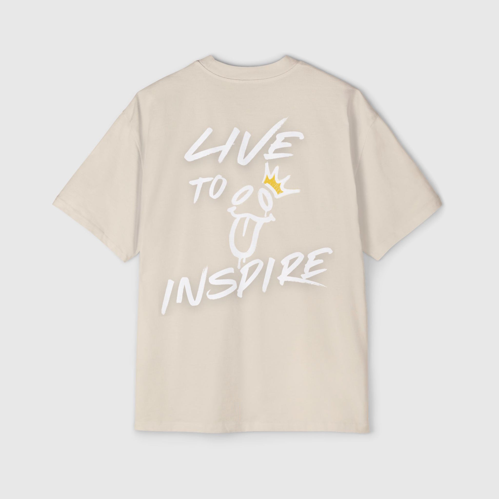  A beige oversized t-shirt laid flat, displaying the "LIVE TO INSPIRE" text and graphic on the back, highlighting trendy men's wear for both gym and streetwear looks