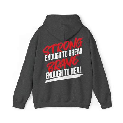 Brave & Unbreakable Men's charcoal grey Hoodie featuring a bold typography print in red and white, stating 'Strong Enough to Break, Brave Enough to Heal.' Designed for gym, street wear, and casual layering in Australian streetwear Men's Clothing.