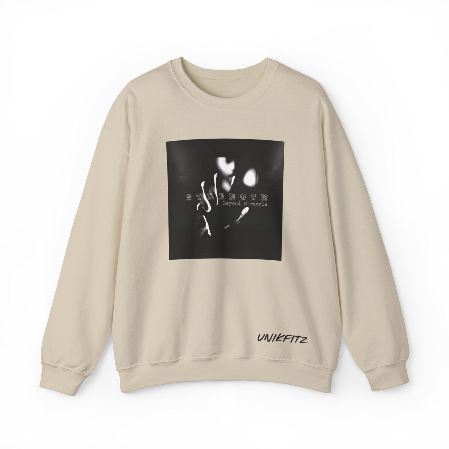 Front view of the Strength Beyond Women's Sweatshirt in beige by UNIKFITZ, featuring a striking black and white print with 'Strength Beyond Struggle' typography. A premium streetwear staple for women’s wear, ideal for gym sessions, urban fashion, and casual layering.