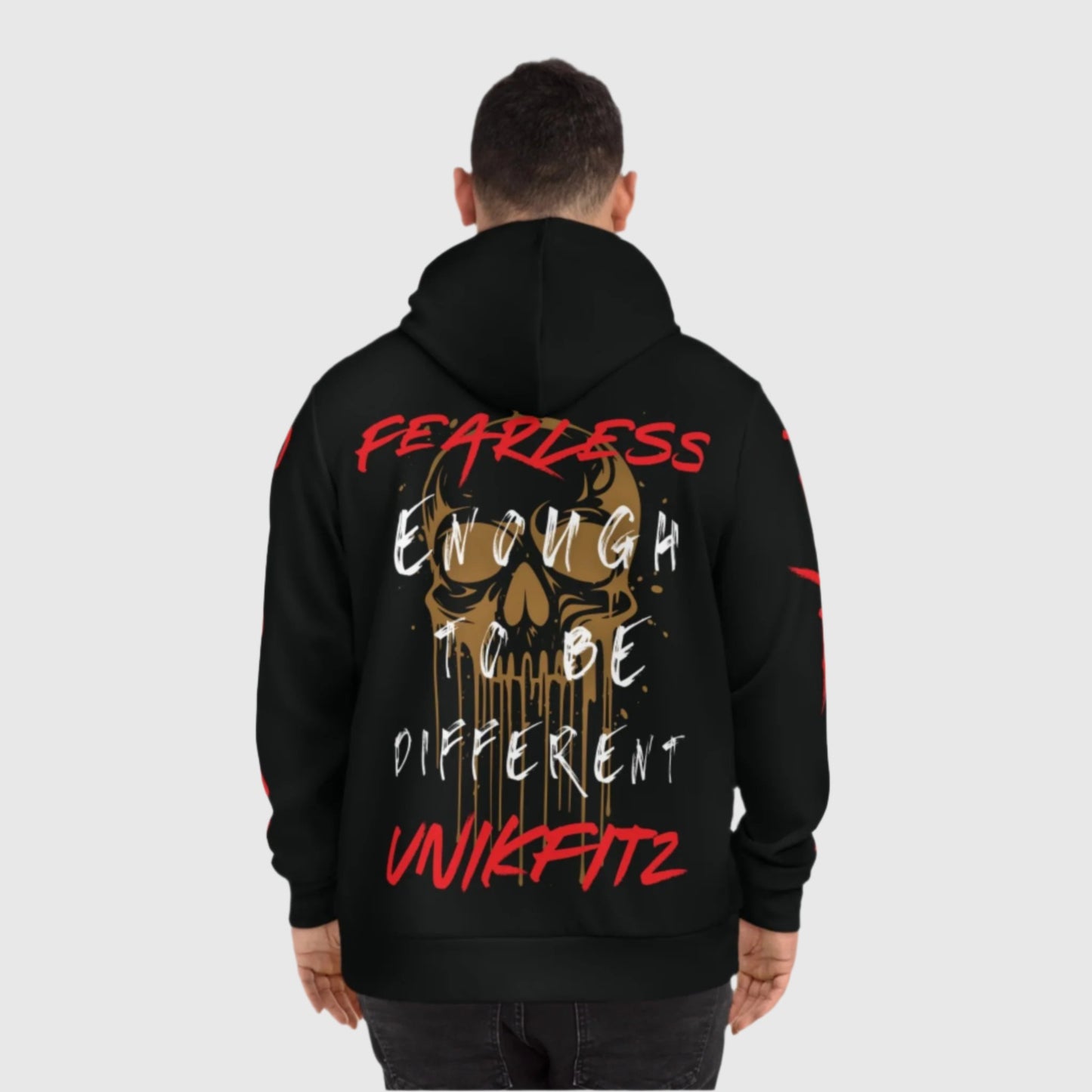 Back view of a black hoodie showcasing a striking gold skull design with the motivational text 'Fearless Enough to Be Different' in white and red lettering, signed with 'Unikfitz.' This stylish hoodie is a street wear essential for men's clothing fans who appreciate bold fashion statements.